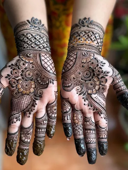 Happy Karwa Chauth. This is a popular style for the festival, with full palm coverage and detailed work on the fingers. I even hid the client's name, Risha, in the design.