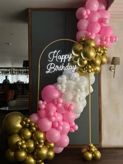 A closer look at our mini balloon backdrop, perfect for parties in space-constrained venues. The combination of pink, white, and gold chrome balloons is both fun and elegant.