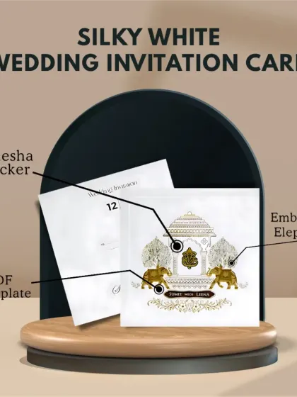 This silky white wedding invitation card features an embossed elephant design and an MDF nameplate for a touch of modern royalty.