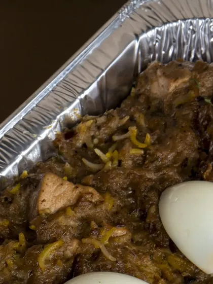 A bulk tray of my flavorful biryani, garnished with boiled eggs. This is how I prepare large orders for parties, ensuring every portion is delicious.