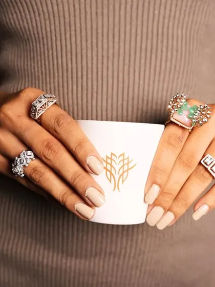 A glimpse into the versatility of my ring collection, showcasing four different statement rings on one hand. Each ring, from classic diamond to colorful gemstone, tells its own story.