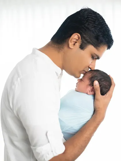 A father's gentle kiss for his newborn. These are the quiet, emotional moments we live to capture, preserving the start of a lifelong bond.