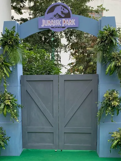 The Jurassic Park gate can be styled with beautiful floral and foliage arrangements for a slightly softer, "wild jungle" look.