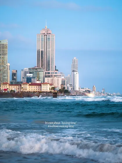 The Colombo skyline as seen from Galle Face Beach. The powerful waves in the foreground contrast with the calm city in the distance, showing the city's close relationship with the sea.