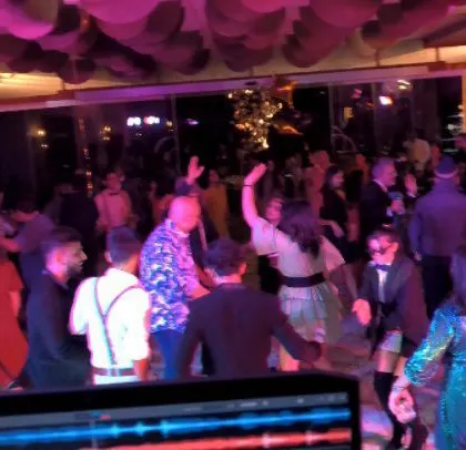 My view from the DJ booth, showing my equipment and the energetic crowd.