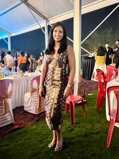 Our client Devika carries off her custom-made Benaras fabric halter dress with poise at an evening event.
