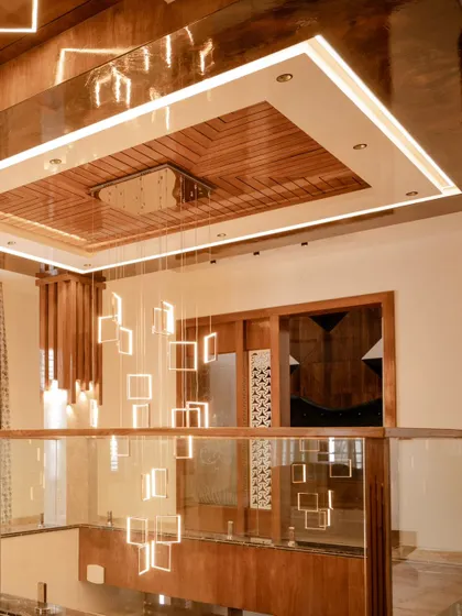 A stunning view from below of the multi-story chandelier, showcasing its modern design and the scale of the lighting installation.