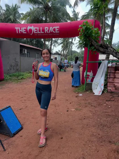 A proud moment at the finish line of "The Hell Race" in Goa, medal in hand. These races are about grit over glory.