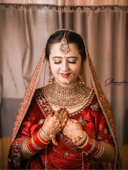 A shy and beautiful bridal portrait, with the bride's eyes closed, capturing a moment of serene happiness.
