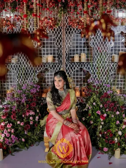 For this Varapuja ceremony, we used a vibrant palette of reds and pinks. The decor included hanging elephant charms and a mirrored backdrop to create a festive and prosperous atmosphere.