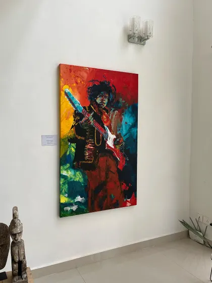 A wider shot of the Jimi Hendrix painting in the gallery. It shows how the piece interacts with the surrounding space and architectural elements.