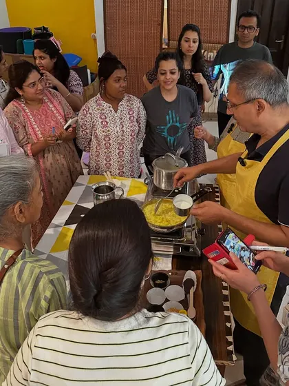 A group gathers around the cooking station, eager to learn the secrets of ashram cuisine. Our workshops are interactive, informative, and full of community spirit.