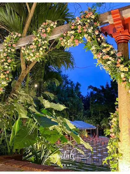 Another view of the beautiful stone arch, with the evening sky adding a dramatic backdrop to the floral decor.