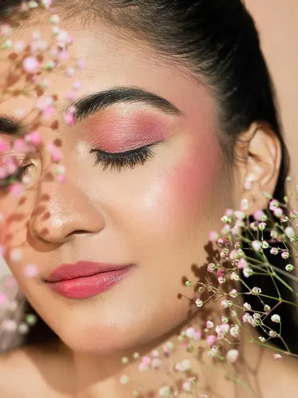 This dreamy shot with baby's breath flowers captures the romantic and artistic nature of the makeup.