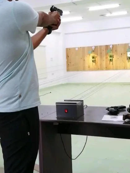 Here I'm helping a student test out a Beretta PX4 Storm CO2 air pistol. It's a realistic replica that's great for some fun target practice.