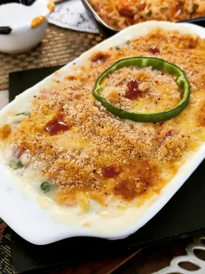 A classic Vegetable Au Gratin, featuring assorted vegetables in a creamy white sauce, topped with breadcrumbs and cheese, then baked until golden and bubbly.
