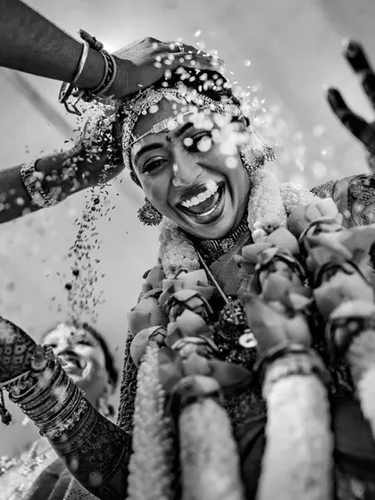 The pure joy of a bride during the Talambralu ritual in a South Indian wedding. This award-winning black and white photo freezes a moment of absolute happiness.