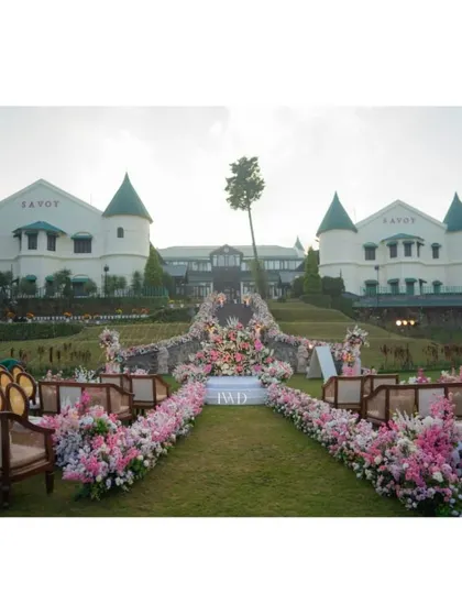The wedding aisle at the Savoy in Mussoorie, ready to welcome guests. The combination of elegant seating, a flower-laden path, and the stunning backdrop showcases our approach to creating immersive and beautiful ceremony environments.