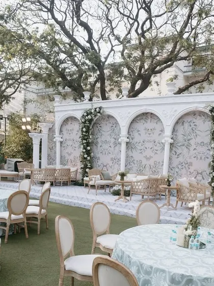 Another angle of the European-inspired lounge area, highlighting the comfortable seating arrangements and the beautiful arched backdrop, perfect for guest mingling.