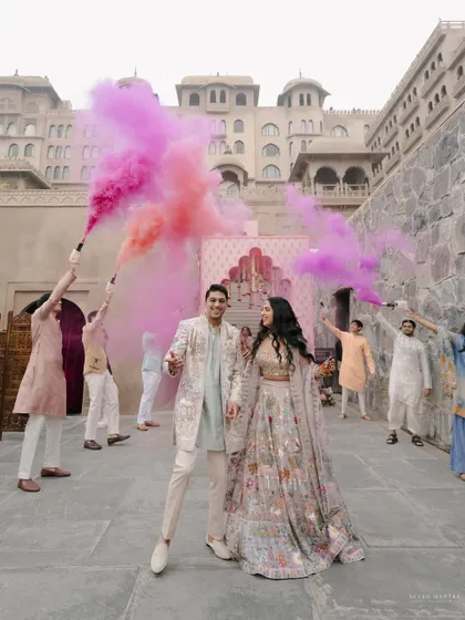Making an entrance with a burst of color. This dynamic shot captures the energy and excitement of Heena and Shlok's pre-wedding celebration at Fairmont Jaipur.