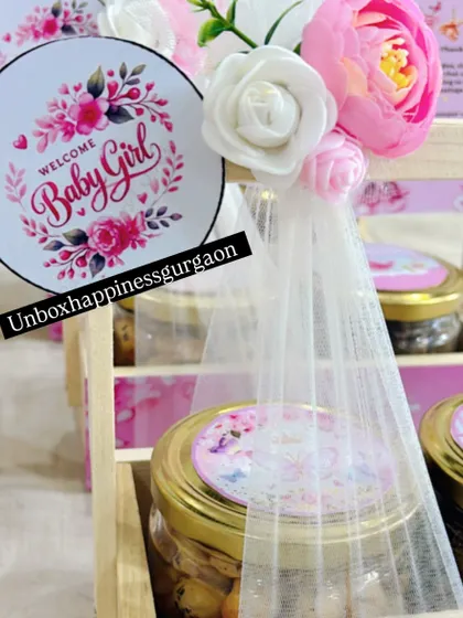 A detailed shot of the "Welcome Baby Girl" tag, showing the beautiful floral wreath design and elegant script.