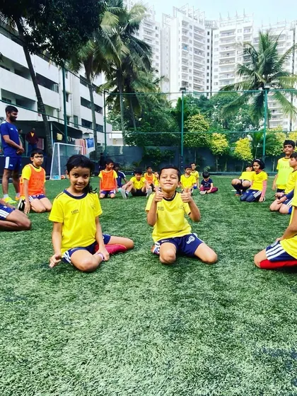 Two young players give a thumbs up. The positive and encouraging environment at our academy makes kids happy to be here.