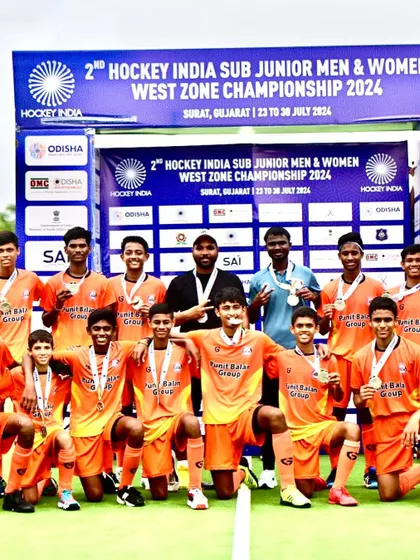 The team celebrating with their medals after a hard-fought tournament.