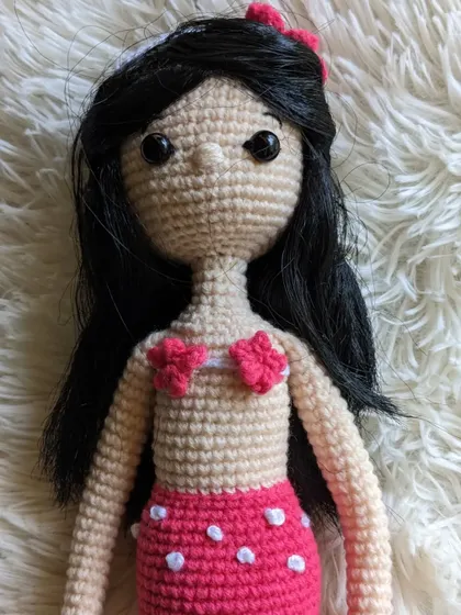 A close-up of the mermaid's torso and tail, which has little white polka dots.