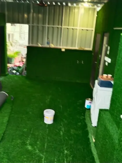 Another angle of the full room grass installation, showing how I covered the counter front as well. This is a bold choice for a themed room or a commercial space.