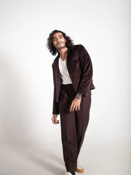 A relaxed, leaning pose that gives the suit a casual, cool vibe.