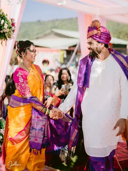 The couple sharing a handshake and a smile on the mandap.