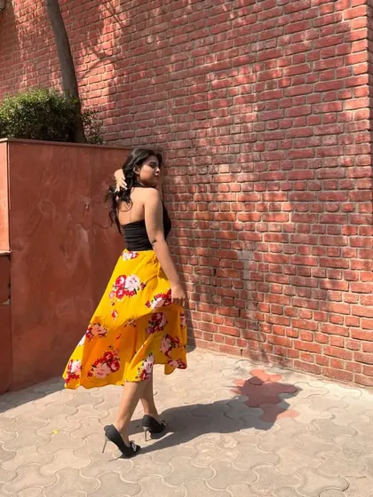 A bright and sunny look for a day on campus. I paired a simple black tube top with a flowy, yellow floral midi skirt and black heels for an effortlessly chic vibe.