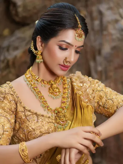 Another angle of our exclusive all-gold bridal set. The matching maang tikka, nose ring, and earrings complete the ensemble, ensuring you look perfect from every angle.