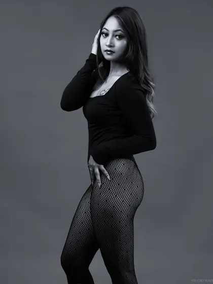A three-quarter length black and white portrait, with a classic and timeless feel.