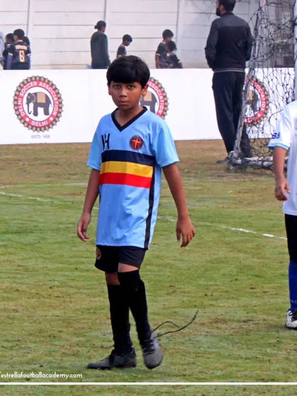 A player looking focused during a Golden League match, with the Delhi Soccer Association branding visible in the background, adding to the event's prestige.