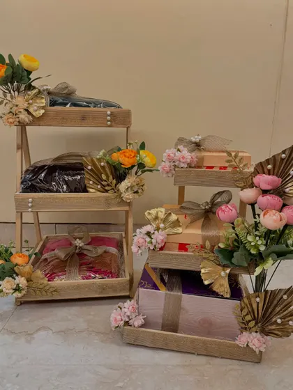A collection of my wedding trousseau packing designs. I use multi-tiered stands and trays, coordinating the floral decor and wrapping to create a cohesive and stunning display of gifts.