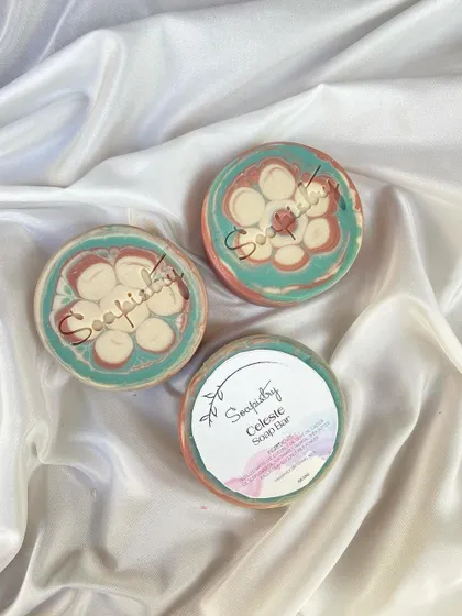 The Celeste soap bar in a round, floral design. The colors are soft and dreamy, and it's a beautiful addition to any soap dish.
