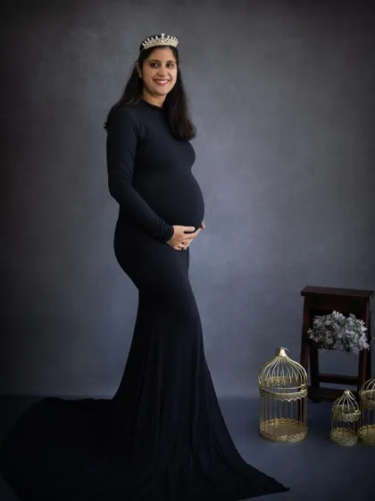 A classic silhouette of a mom-to-be in a black gown and crown. This timeless style is always a favorite for capturing the elegance of pregnancy.