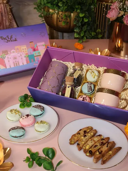 Another view of our High-Tea Hamper, showing the beautiful ceramic cups, macarons, and biscotti jar. It's a complete and luxurious tea-time experience in a box.