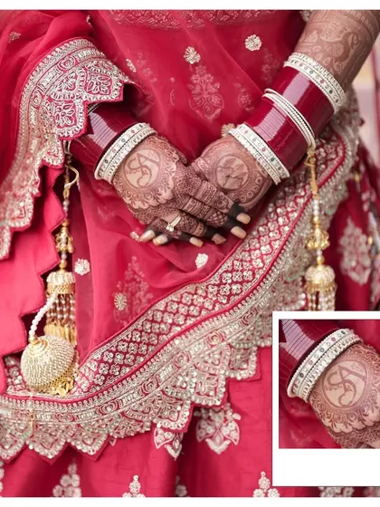 A detailed shot of the bride's hands, showcasing her intricate henna design and the traditional chooda. These details are an important part of the bridal story.