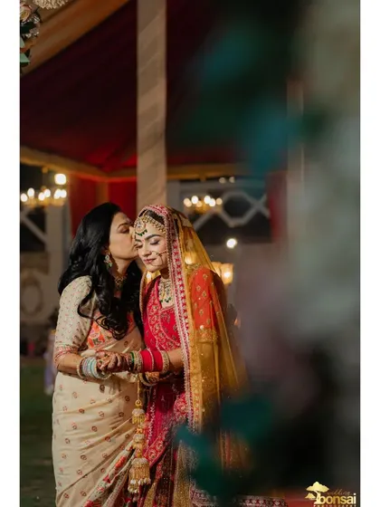A sweet moment between the bride and her sister or friend.