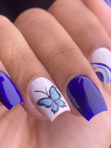 A close-up shot focusing on the intricate details of the hand-painted butterfly and the abstract wave pattern.