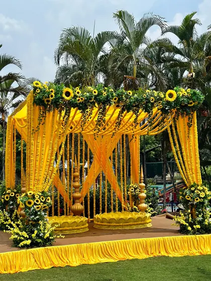 The Haldi ceremony is all about vibrant joy, and we love bringing that to life. Here, a classic mandap is transformed with bright yellow marigold garlands and fresh sunflowers for a sun-kissed, outdoor celebration.