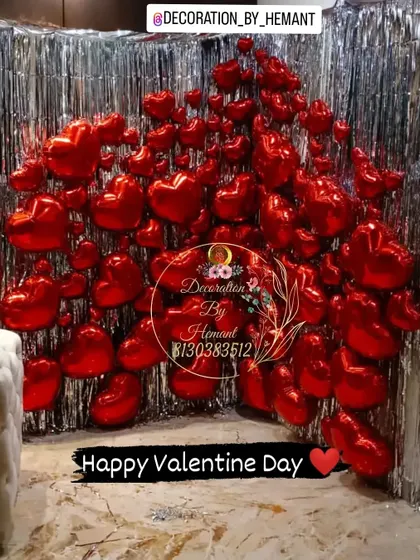 To make a bold romantic statement, I can design high-impact backdrops like this one. A wall filled with red heart-shaped foil balloons against a silver tinsel curtain creates a dramatic and fun photo opportunity for Valentine's Day or a proposal.