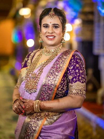 A full view of Anusha's stunning outfit for the naming ceremony. The heavily worked purple blouse provides a beautiful contrast to the soft lavender of her silk saree.