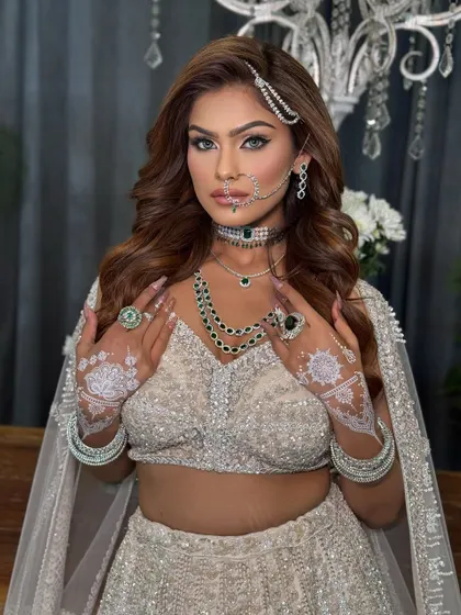 This look is all about high-glam. I created voluminous, side-parted waves to frame the face and add drama, perfect for a bold reception or cocktail party look.