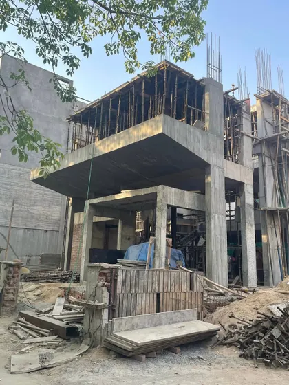 **Dwelling in Splits, Ahmedabad:** A repeat of the construction photo, emphasizing the raw, powerful form of the split-level concrete structure.