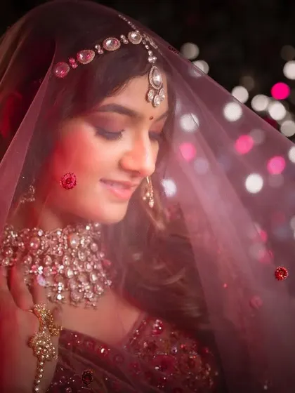 A beautiful close-up of Jenisha under her veil. The soft lighting and bokeh effect create a truly magical and romantic atmosphere.