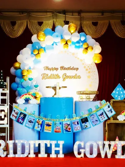 A cheerful first birthday party for Ridith Gowda. The blue and yellow color scheme, along with a custom photo banner, makes for a bright and personal celebration.