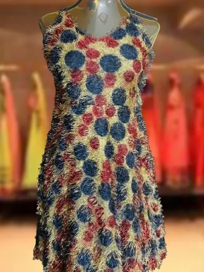 Stand out in this unique party dress with a textured, fuzzy polka dot pattern. The halter neckline and A-line shape make it a fun and comfortable option for any celebration.